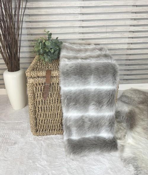 Striped fur blanket with matching fur cushion