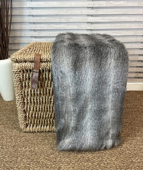 Long haired grey striped fur bedspread