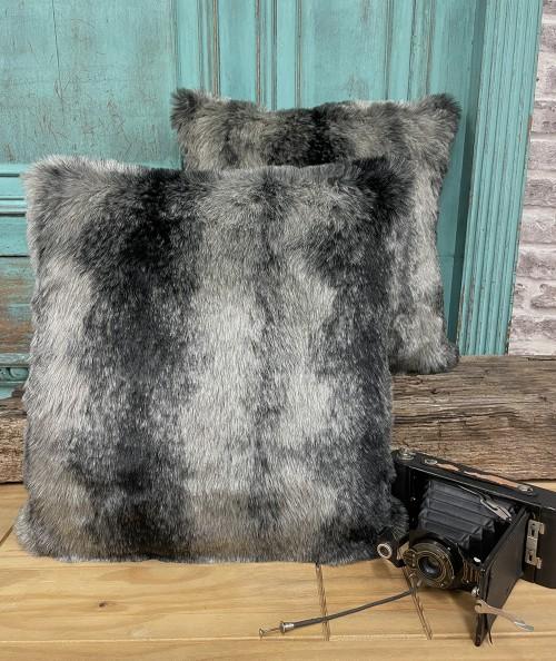 Fluffy cushions in a grey and black striped fake fur