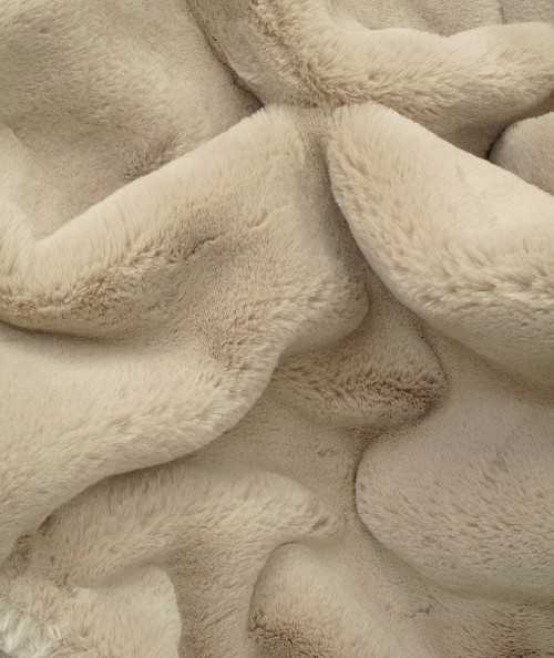 Close up image of the luxury beige faux fur throw